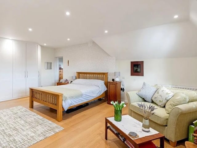 The 21ft principal bedroom has fitted cupboards and wooden shutters to the window, which has views to the top of the South Downs. Picture: Savills - Haywards Heath.
