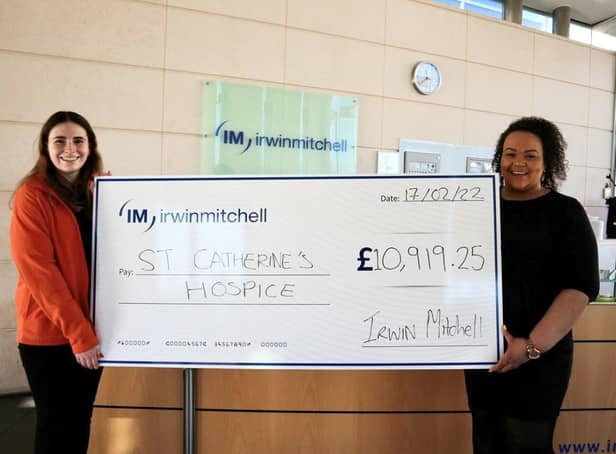 Emma (left) from St. Catherine’s Hospice in Crawley receiving a cheque from Irwin Mitchell's Lacey St James (right) SUS-220321-181539001