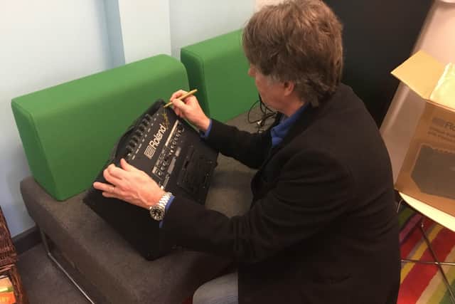 Guy signs a donated amp