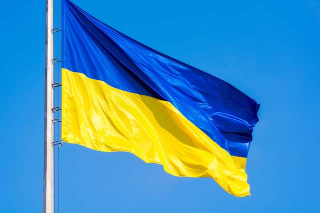 Ukrainian flag against a blue sky. Yellow and blue colors. National symbol of Ukraine. SUS-220322-115951001