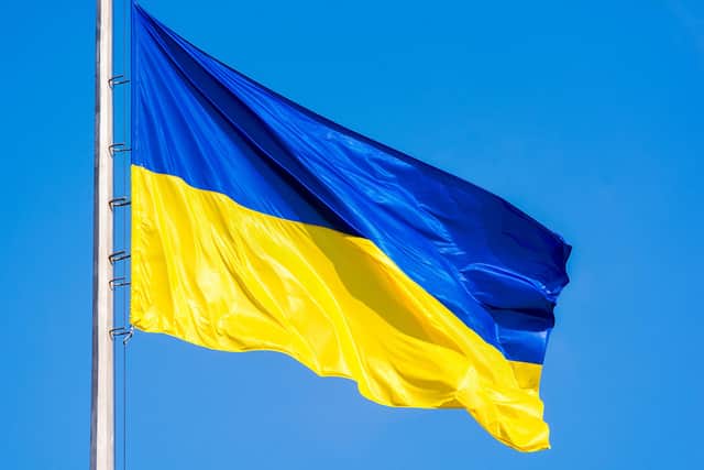 Ukrainian flag against a blue sky. Yellow and blue colors. National symbol of Ukraine.