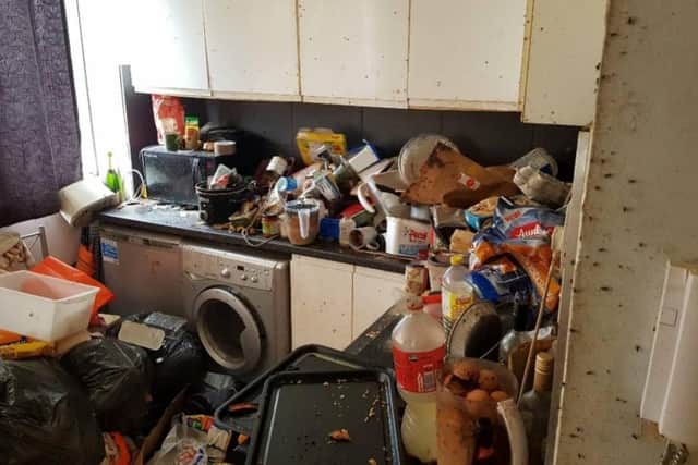 The flat was full of rotting food on kitchen surfaces, bags of human excrement on the walls, and 'many black bin bags of rubbish'. Photo: Sussex Police