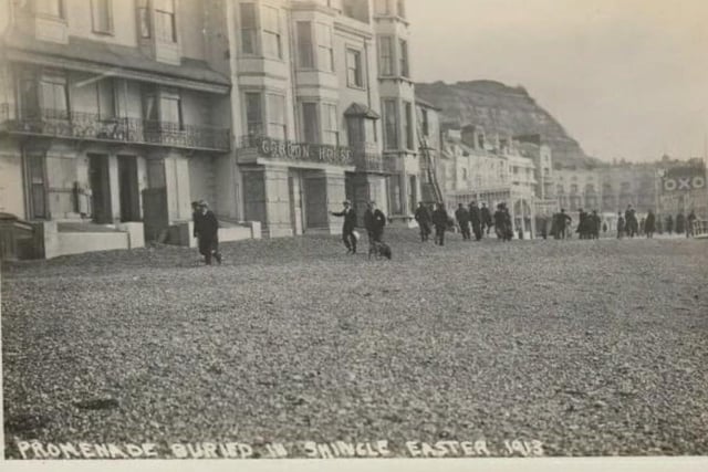 Hastings Storm. The road and promenade at Denmark Place covered in shingle. SUS-220325-124800001