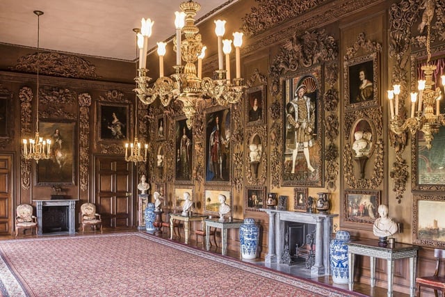 The Carved Room, with the four paintings by Turner restored to the panelling, looking South at Petworth House and Park, West Sussex. The carvings are by Grinling Gibbons. Henry VIII portrait hangs over fireplace. ©National Trust Images Andreas von Einsiedel