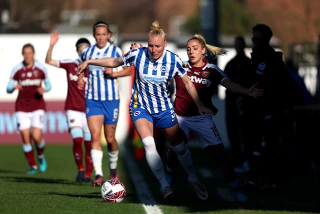 Brighton's Danique Kerkdijk and West Ham's Adriana Leon tussle to keep the ball in play