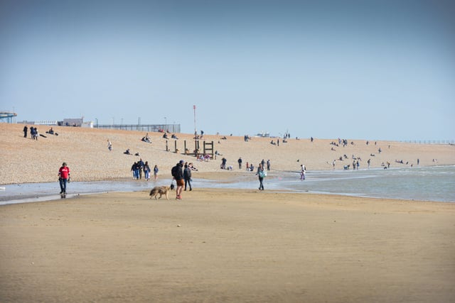 People enjoying the warm March weather on Hastings beach. Photo taken on March 26. SUS-220326-133122001