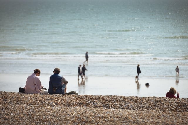People enjoying the warm March weather on Hastings beach. Photo taken on March 26. SUS-220326-132925001