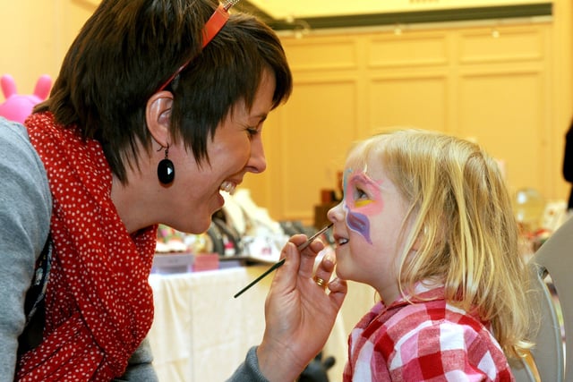Sue Richards painting the face of Ella Rawcliffe, three, at the craft fair for Comic Relief