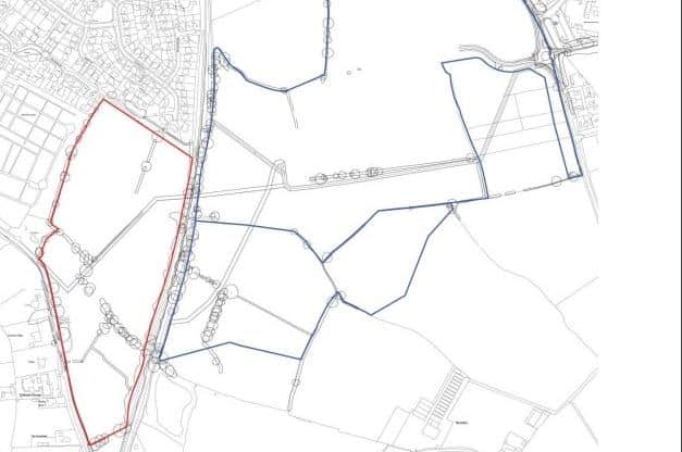 The first phase is outlined in red, the rest of the site is edged in blue