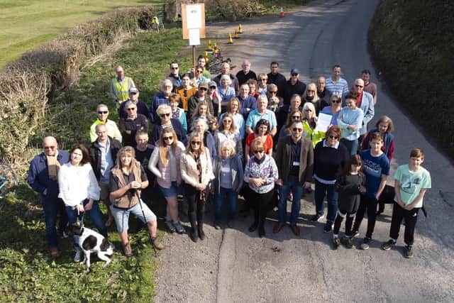 Up to 100 residents of Burpham, Wepham and Warningcamp gathered on Saturday morning (March 26), before marching to The George pub to share details of 'near collisions and blowouts' as well as cyclists 'being driven off the road' as cars swerved to avoid potholes on blind corners. Photo: Eddie Mitchell
