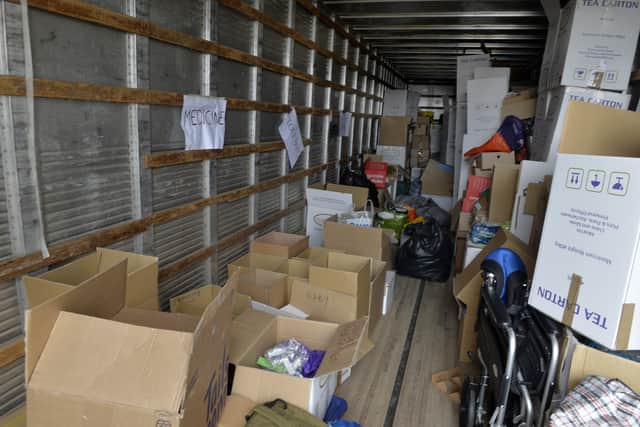Mariia Savvinova is collecting donations for Ukraine and loading them on to a lorry at JWD Removals (Photo by Jon Rigby) SUS-220330-132517008