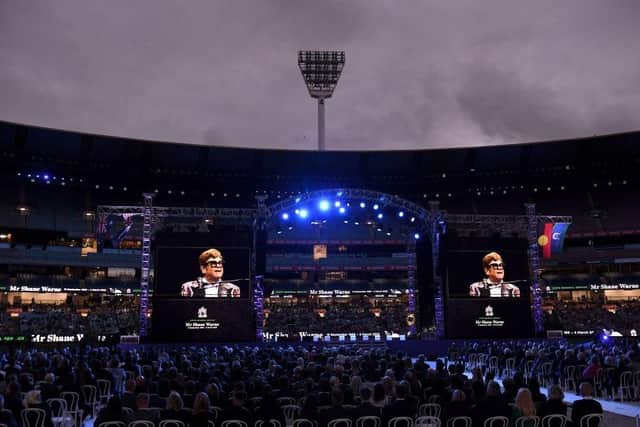 Elton John sings a dedicated song during the state memorial service for the former Australian cricketer Shane Warne at the Melbourne Cricket Ground (Photo by WILLIAM WEST/AFP via Getty Images)