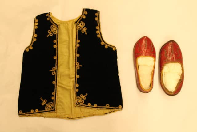 The black velvet waistcoat embroidered with gilt braid and the red leather shoes with silver wire embroidery that Burgon can be seen wearing in the portrait of him as a child