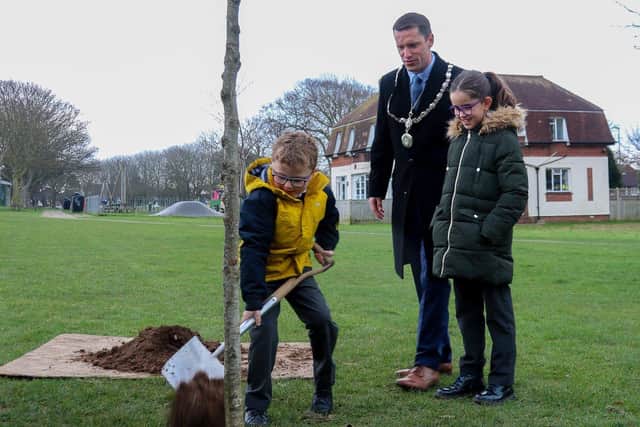 Adur District Council chairman Stephen Chipp and his children Samuel, six, and Eloise, ten, planting an English oak in Buckingham Park, Shoreham