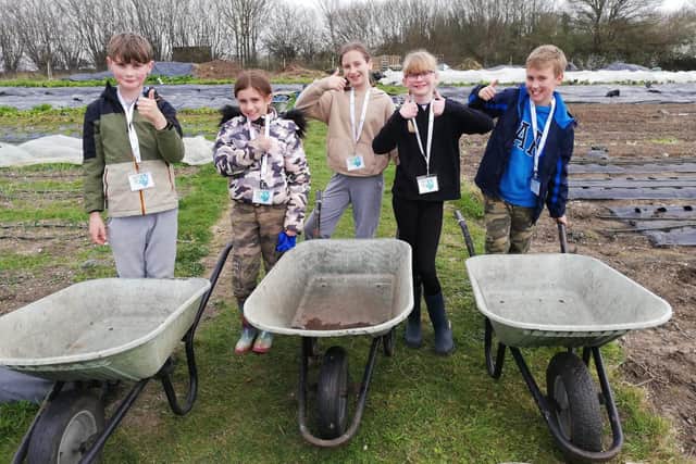 Students competed to see who could fill up their wheelbarrows the fastest