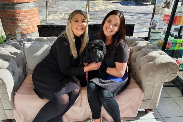 Alana (left) and Courtney (right) with Lucy the dog.