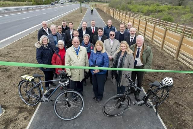 Joy Dennis, the County Council’s Cabinet Member for Highways and Transport, cut a ribbon across the new shared-use path to mark the official opening of the A2300 improvement scheme. Picture: West Sussex County Council.