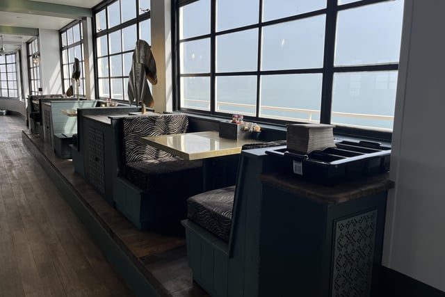The booth seats are secluded from the main restaurant with a view of the ocean