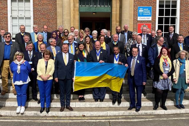 West Sussex county councillors show solidarity with the people of Ukraine on the steps of County Hall