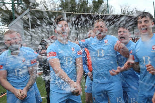 The celebrations get started after Hastings United clinch the Isthmian south east title with a point at Faversham / Pictures: Scott White