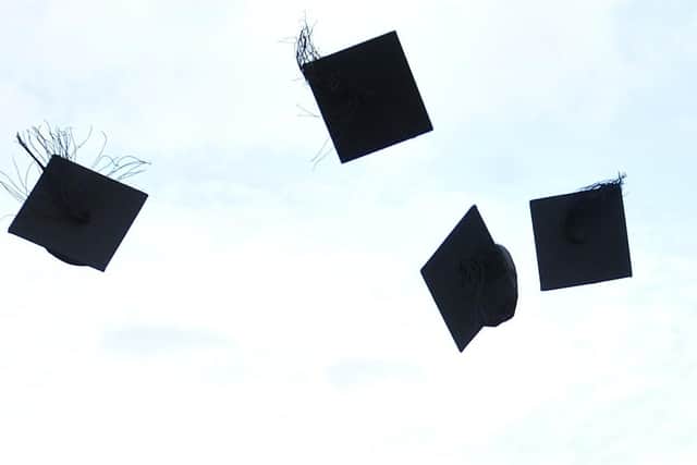 Mortar boards tossed in the air at a graduation ceremony