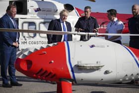 DOVER, ENGLAND - APRIL 14: Prime Minister Boris Johnson looks at a Coastguard drone used for surveillance and the rescue of migrants, as he meets crews and technical staff at Lydd Airport on April 14, 2022 in Dover, England. The UK government announced that they will process people seeking asylum in Britain 4,500 miles away in Rwanda in an effort to crack down on unauthorised migration. (Photo by Matt Dunham - WPA Pool/Getty Images) SUS-220414-130020001
