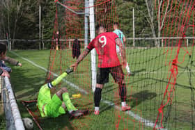 In the net - but it's the keeper not the ball