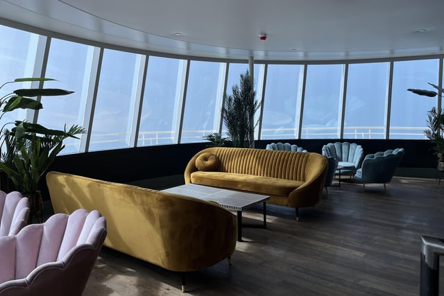 The cocktail lounge is on the first floor with fancy seats where people can look out to sea