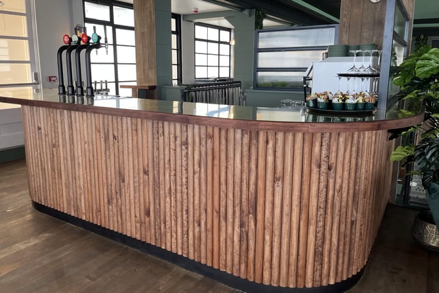The wooden bar on the first floor serving all types of drinks for people to enjoy whilst looking out to sea