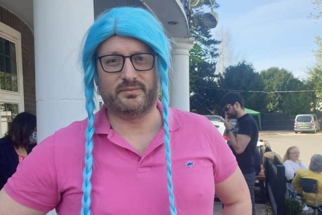 Mark Dunford wearing a bright blue wig after agreeing to take part in the British and World Championships for The Shots
