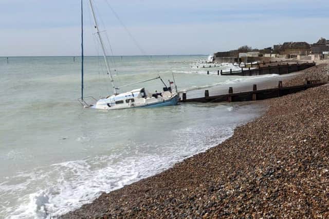 The yacht partially submerged on the seafront near Elmer on April 17. Picture by RNLI/Harry Gregory SUS-220418-141811001
