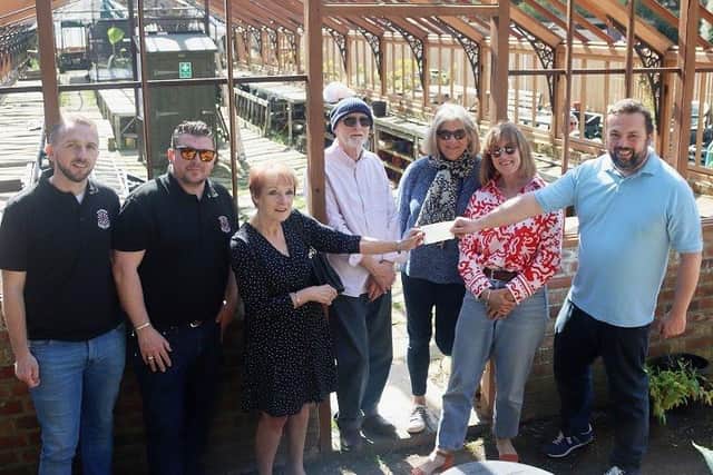 Greenhouse group treasurer Ann Hodkinson receives the £5,000 cheque from Hastings Round Table vice-chairman Rob Lee, accompanied by Round Table and greenhouse group members. SUS-220419-161940001