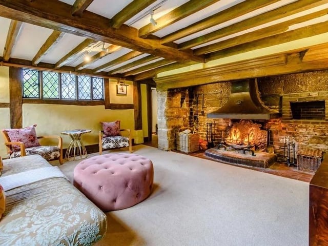 The rear aspect sitting room has an inglenook fireplace. Picture: Strutt & Parker - Horsham.