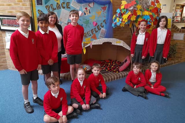 Holy Trinity Church of England Primary School in Cuckfield received a 'good' rating in its recent SIAMS report. From left: Dylan, Amine, Arlo, headteacher Ann MacGregor, Euan, Joesphine, Jack, Romy, Eva, Jemima and Lily.