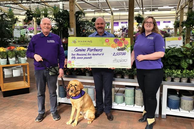 Nick Joad, general manager for Haskins Roundstone, presents the cheque to Canine Partners foster co-ordinator Ewen Macdonald and community engagement officer Gemma Tupper