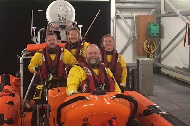 New Brighton lifeboat helm, Mat Humphrey (centre sat down) and trainee crew member Rhiannon Darling (centre rear)       Photo/RNLI
