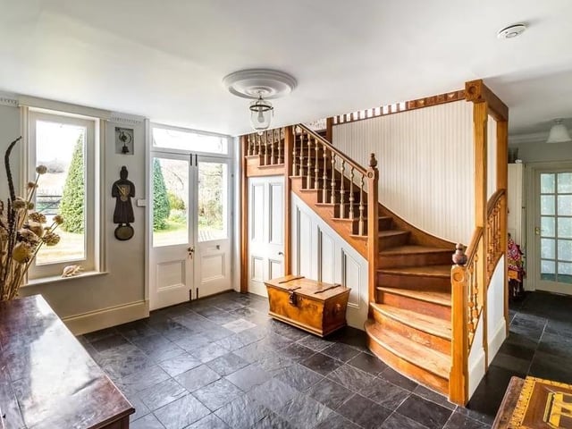 The entrance hall has slate flooring and a central main staircase. Picture: Hamptons - Haywards Heath Sales.