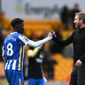 Graham Potter celebrates victory with midfielder Yves Bissouma after Brighton and Hove Albion's Premier League victory at Wolves
