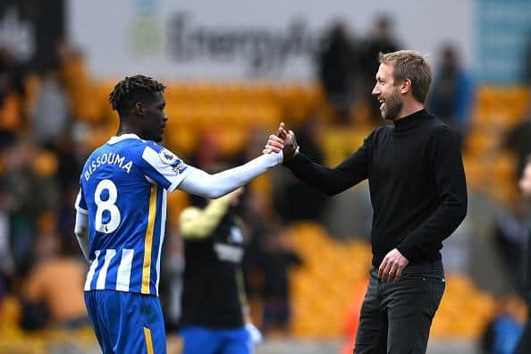 Graham Potter celebrates victory with midfielder Yves Bissouma after Brighton and Hove Albion's Premier League victory at Wolves
