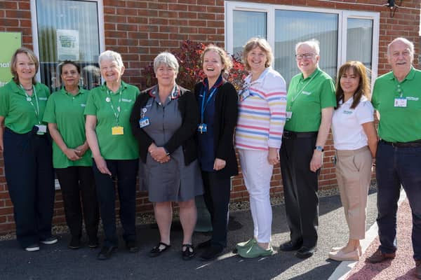 QVH Macmillan Centre volunteers (green tops) are joined by Nicky Reeves, QVH chief nurse (in grey dress), Tania Cubison, QVH medical director (stripy top), and QVH Cancer Nurses