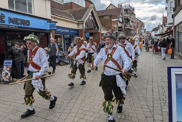 Another Morris dance troupe armed with stick and bells in the town centre