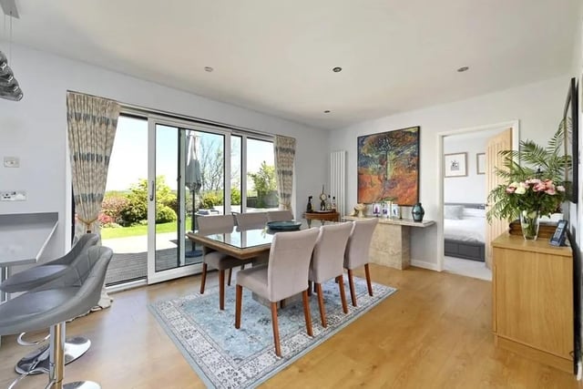 The open plan living space includes an entrance hall leading to the lounge with a feature fireplace and a dining area adjoining the kitchen. Picture: Mishon Mackay.