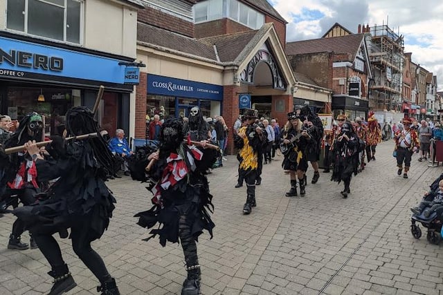 A steam-punk themed Morris dancing group dance along the street
