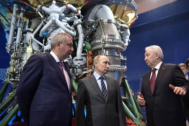 Russian President Vladimir Putin (C) and the State space corporation Roscosmos head Dmitry Rogozin (L) listen to Director of Russian rocket engine manufacturer NPO Energomash Igor Arbuzov in Khimki, outside Moscow on April 12, 2019. (Photo by Alexey NIKOLSKY / SPUTNIK / AFP) (Photo by ALEXEY NIKOLSKY/SPUTNIK/AFP via Getty Images)