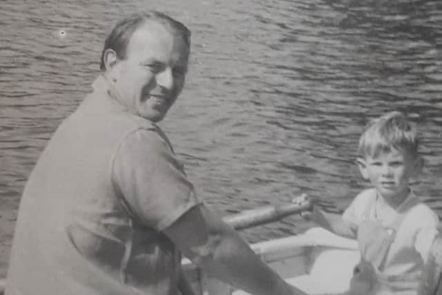Charles with his dad Tommy rowing on the lake