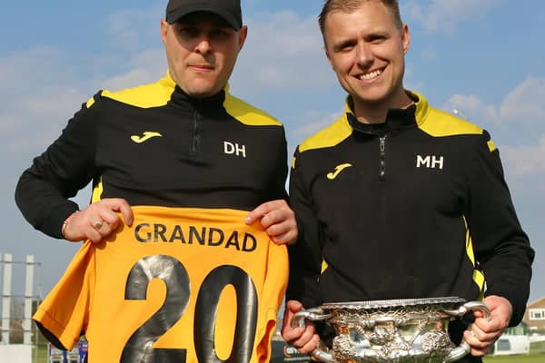 Danny and Mitch Hand with the SCFL trophy and a shirt that's a tribute to their grandad Dave