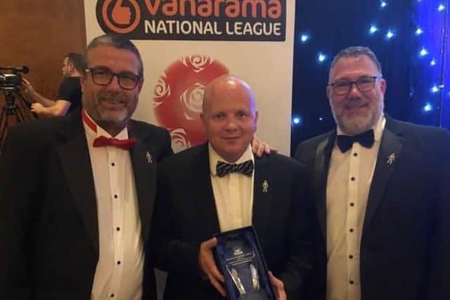 Eastbourne Borough's bosses with their National League South award