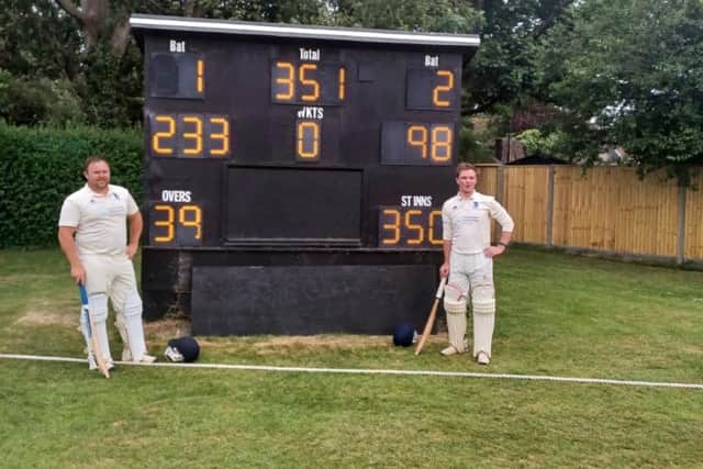 Alex Maynard and Ben Cartwright with the scoreboard displaying their amazing winning partnership