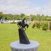 A competitor in the Al Shira'aa Derby at Hickstead, West Sussex, with the Boomerang Trophy in the foreground. Photo (c) Craig Payne
