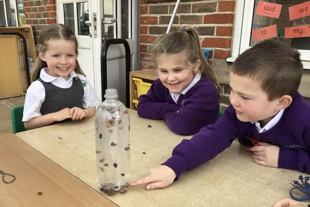 Reception pupils with their dried fruit lava lamp, made using lemonade